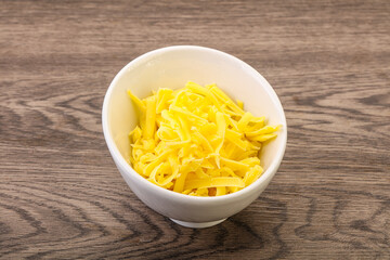 Shredded yellow cheese in the bowl