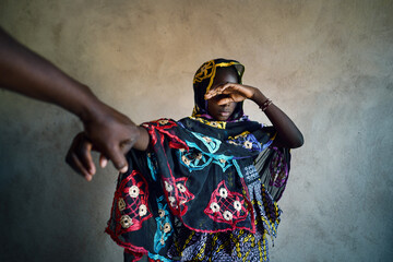 Ashamed african girl cover her face from camera