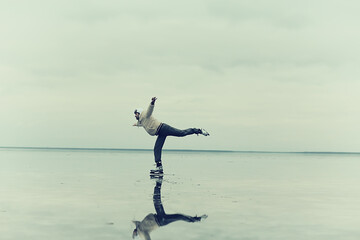 one guy skates on the ice of a frozen lake, nature landscape, man outdoor sports