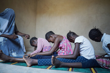 Group of young children perform ritual
