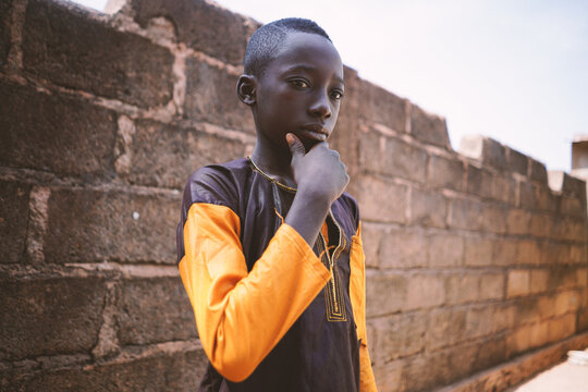 Black Malian boy stand alone with sad eyes