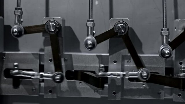 Steel levers of old fashioned engine move when engine is running. Simple mechanics and steampunk concept.