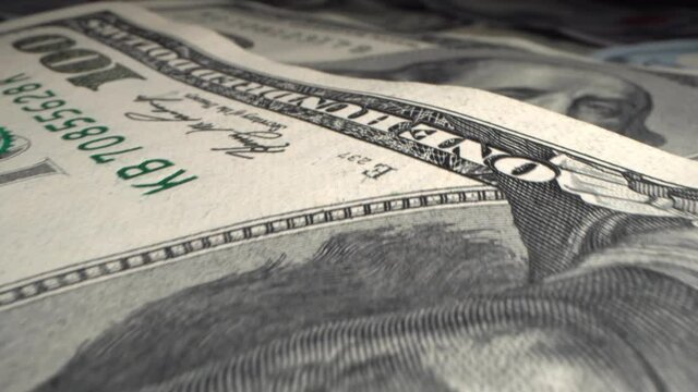 Christmas spending concept. Hundred-dollar money of the United States of America very close-up. Portrait of Franklin on a paper bill macro. Business, income and expense concept