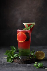 Fresh watermelon juice with lemonade, melon syrup and fresh mint leaves on vintage background