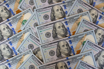 A pile of one hundred US banknotes. Cash of hundred dollar bills, dollar background image.