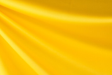 draped yellow silk fabric of satin weave, texture, background