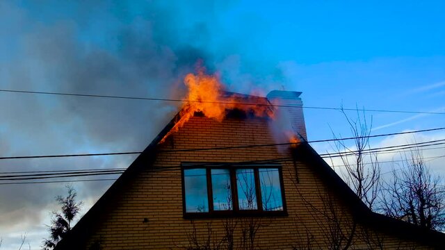 The roof of the house is on fire. Selective focus.