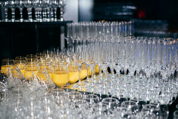 transparent glasses and glasses with juice lined up and ready to receive guests