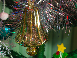 A Christmas toy on a Christmas tree. Christmas toys on the green branches of the Christmas tree. Decorations and a burning garland on the Christmas tree.