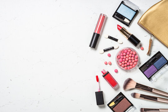 Make up products and cosmetic bag. Professional cosmetics at white marble background. Flat lay image.
