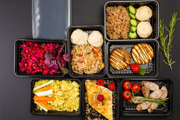 Ready healthy food catering menu in lunch boxes meat and vegetable packages on black table background