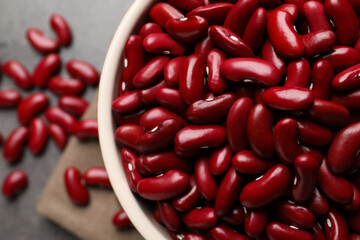 Bowl of raw red kidney beans on table, top view