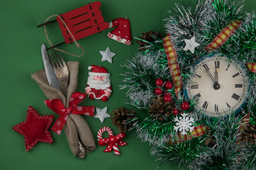 Colorful rustic festive place setting with a knife and fork tied in a vivid festive Christmas napkin with string resting on a wooden table with copyspace