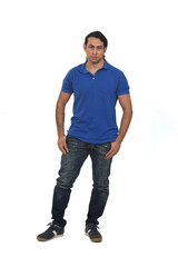 Fototapeta premium front view of a man with long hair and tattoo looking at camera on white background