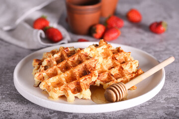 belgian waffles with honey are on the table
