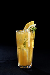 refreshing alcoholic drink with berries, ice vodka and gin, lemon peel served in glass cup on the counter on blurred background