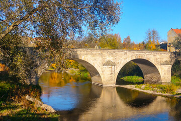 Fototapeta na wymiar Beautiful old bridge over the river on a sunny day.