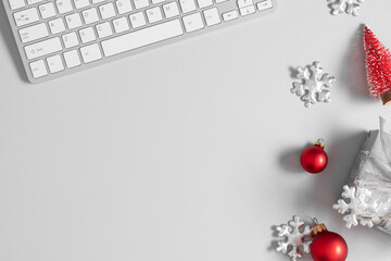 Christmas or New Year background. Office table, christmas decorations, keyboard on gray table. Flat lay, top view, copy space