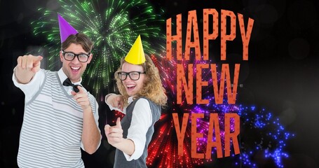 Digital composite image of happy young couple enjoying new year against firework