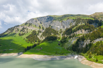 The countryside around the Dam of Saint Guerin in Europe, in France, towards Beaufort, in the Alps, in summer, on a sunny day.