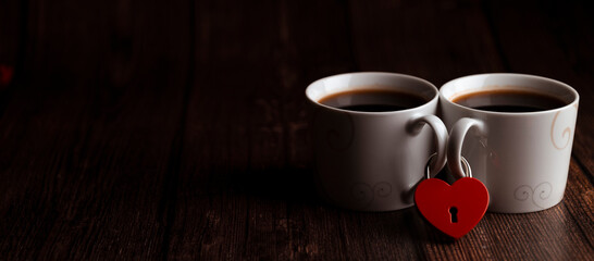 two coffee mugs are fastened with a red heart-shaped lock, Valentine's Day, the concept of love