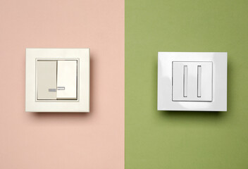 Light switches on color background, flat lay