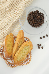 Slices of garlic breads in a rattan baske with coffee beans.
