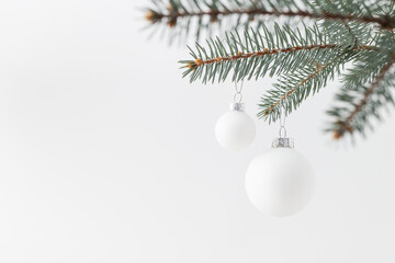Fototapeta na wymiar Christmas tree branch with white holiday balls. Copy space.