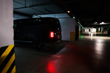 Black van in parking garage at night