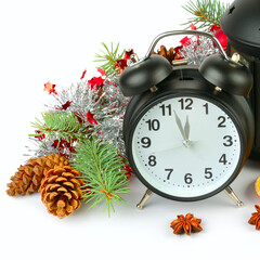 New Year and Christmas decor: retro alarm clock, spruce branch and shiny decorations isolated on white .