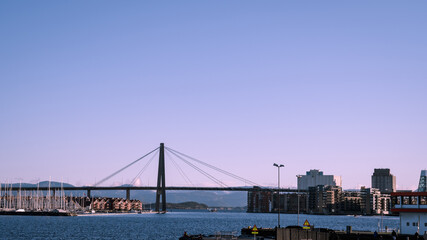 Scenic cityscape of modern norwegian town. Modern architecture of Stavanger. Sunny day. Huge bridge over fjord.