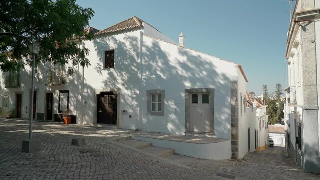 Portuguese streets in the southern town of Tavira, with historic traditional houses. Shooting with a stabilizer.