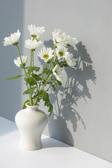 white porcelain vase with small chrysanthemum flowers.