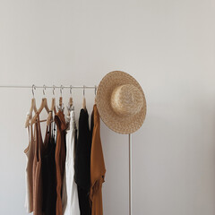 Aesthetic minimalist fashion influencer blog concept. Female dress, tops, t-shirts, straw hat on...