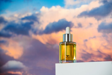 face oil on podium and sky background