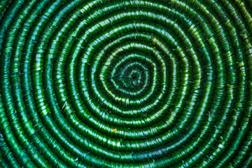 Jute knitted fabric, Handmade: jute and crochet hooks, a circle of jute is tied, close-up, Green background, texture.