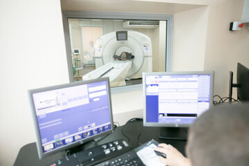 The doctor conducts magnetic resonance therapy to the patient.