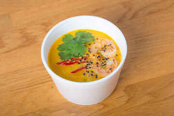 Asian soup, street food, pumpkin with shrimp