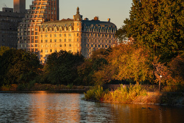Fototapeta na wymiar Upper West Side Sunrise and reflection on the Central Park Jacqueline Kennedy Onassis Reservoir. Autumn in Manhattan, New York City