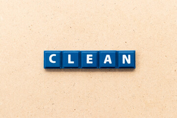 Tile letter in word clean on wood background