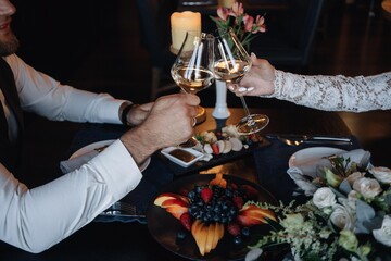 Glasses in the hands of the bride and groom