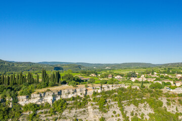 The beautiful town of Aigueze and its vineyards around in Europe, France, Ardeche, in summer, on a sunny day.