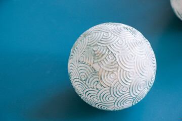 Ball on the blue background, painted christmas ball