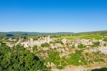 Fototapeta na wymiar The panoramic view of the town of Aigueze and its green countryside in Europe, France, Ardeche, in summer, on a sunny day.
