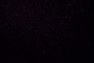 Glittering festive red and black background. Concept of New Year celebration. defocused blurred background