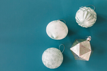 New year toys, christmas tree toys, white and gray toys on the blue background, daylight