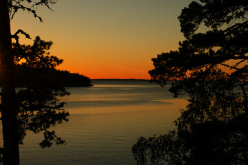 Fototapeta na wymiar Beautiful sunset over the northern lake on a summer evening.