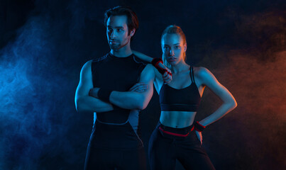 Sprinter run. Strong athletic woman and man running on black background wearing in the sportswear....