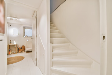 Wonderful snow-white wooden staircase in an elite house