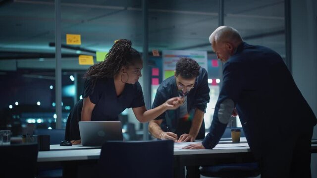 Office Conference Room Meeting: Diverse Team of Top Managers Talk, Negotiate, Use Laptop Computer and Tablet. Business Partners Presenting Branding Strategy, Creative Vision and Marketing Campaign.